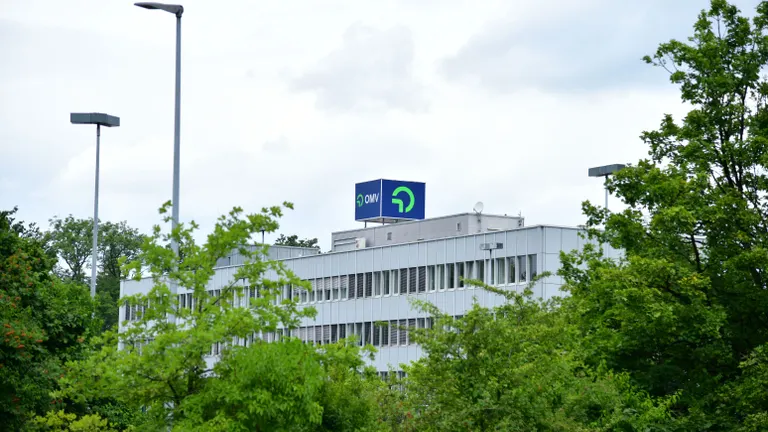 Refinery towers and pipelines under blue sky