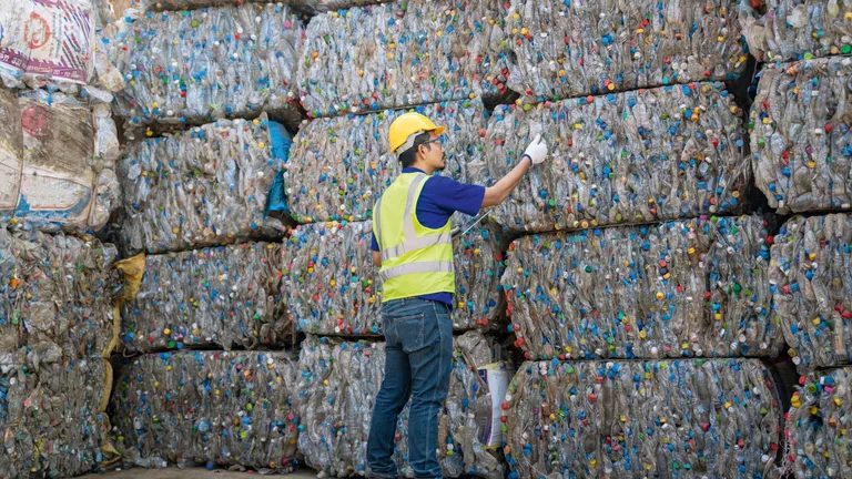 Worker at a recycling collection facility
